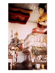 A Young Girl Praying in Front of a Giant Buddha Statue - Art Print | Poster Prints from Posterazzi