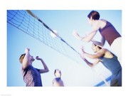 Low angle view of two young couples playing beach volleyball 24.00 x 18.00 Poster Print