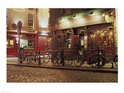 Bicycles parked in front of a restaurant at night, Dublin, Ireland - Art Print | Poster Prints from Posterazzi